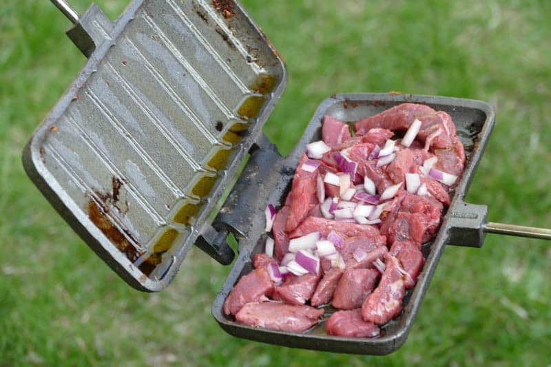 Lining The Pie Iron With Steak and Onions