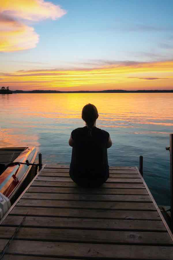 Person sitting on a dock in Hayward, Wisconsin