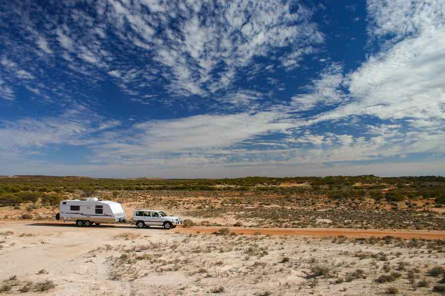 Travel Trailer in the Desert Beyond The Tent