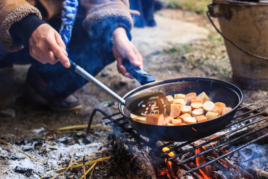 Making a backpacking meal on the fire.
