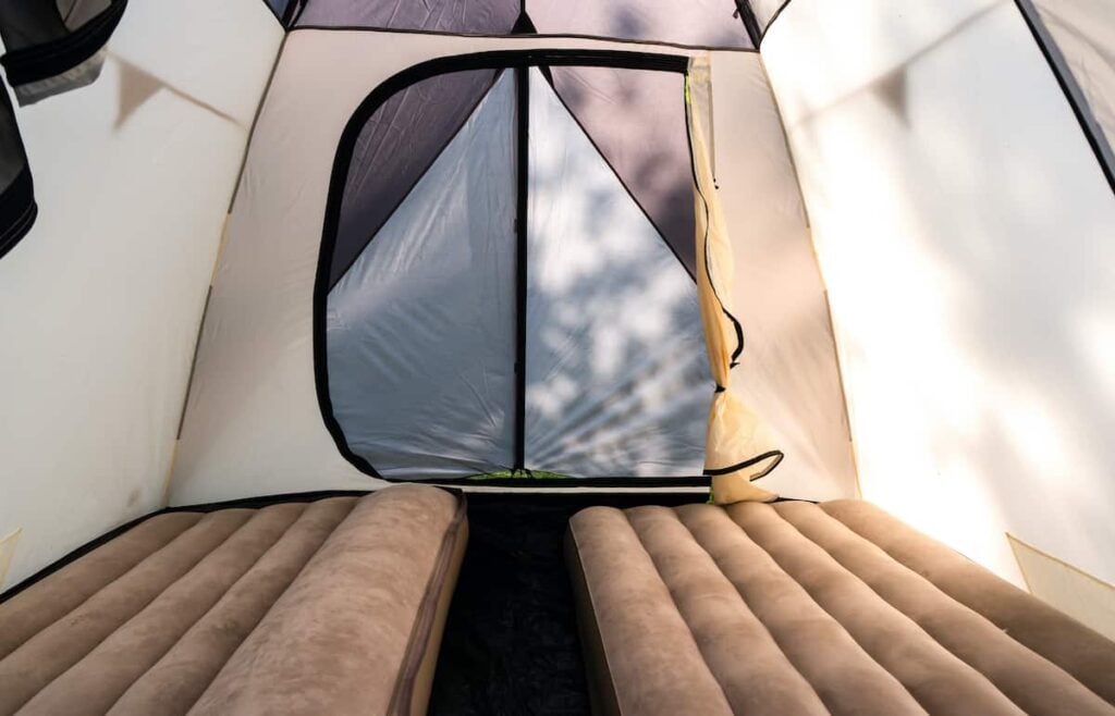 A tent with two air mattresses inside. The best air mattress for camping lets you get a good night's rest as part of your great camping trip.