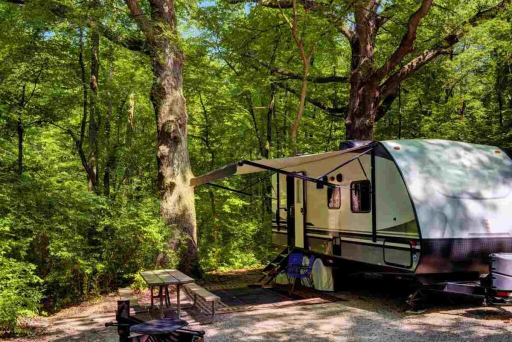 The 16 Best Places to Go Camping in Kentucky 2 An RV set up at a wooded campsite.