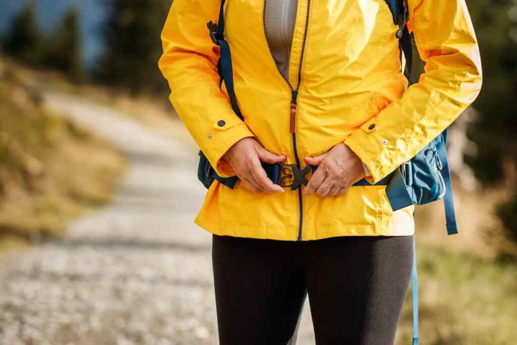 How to Pack a Backpack for Backpacking 2 A woman adjusting the hip strap of a backpack.