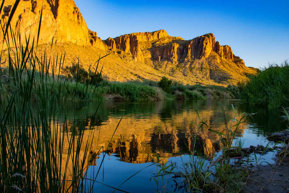 Tonto National Forest Camping Guide 2 View of rock cliff by the Salt River at sunset. Tonto National Forest camping trips are full of beautiful desert scenery.