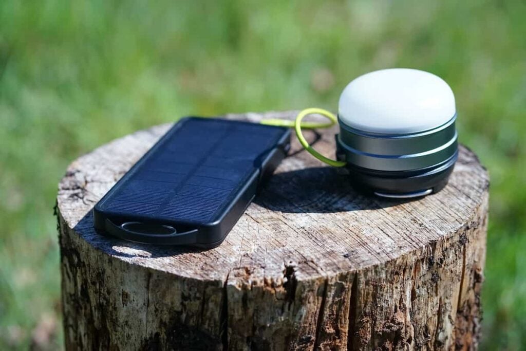 A solar charger for camping charging a camping light.