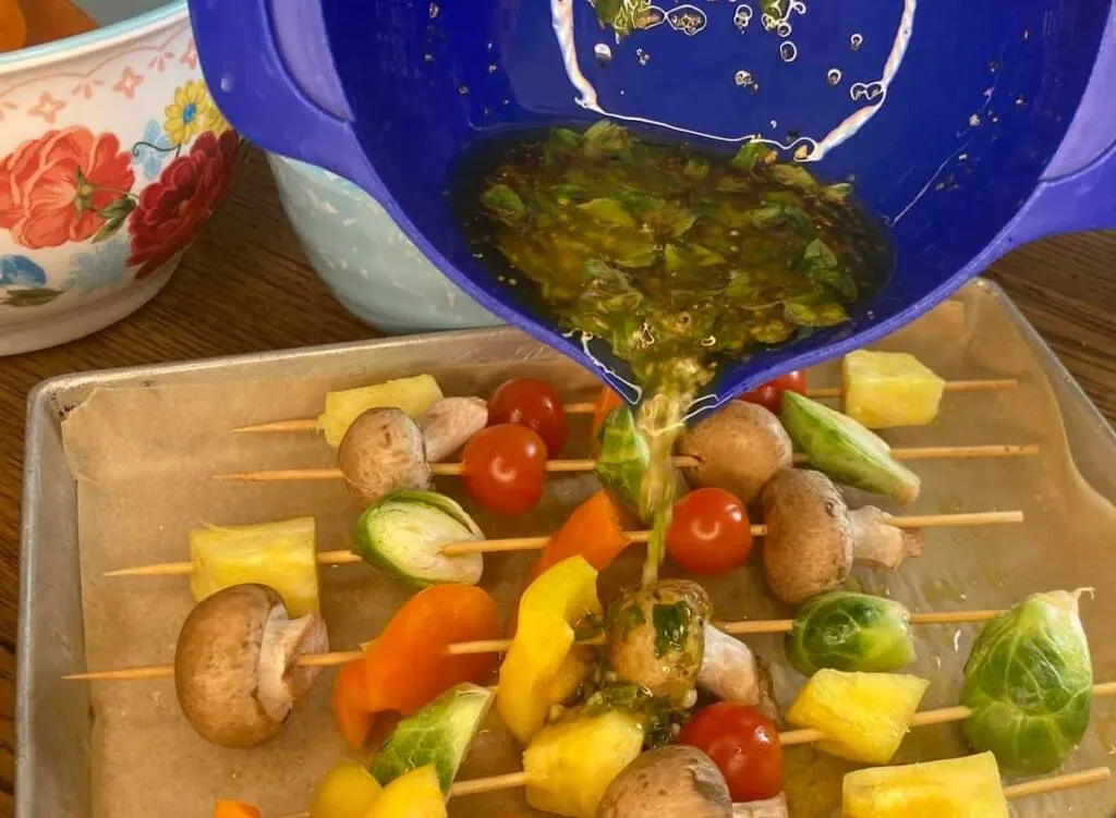 Grilled Veggie Kabobs: A Colorful and Healthy Camping Side Dish 11 Pouring marinade over kabobs.