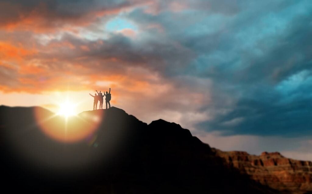12 Trails for the Best Hiking in Arizona 13 Three hikers silhoutted against the sky at the Grand Canyon.
