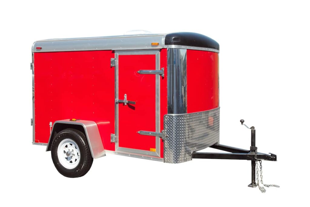 A red enclosed utility trailer.