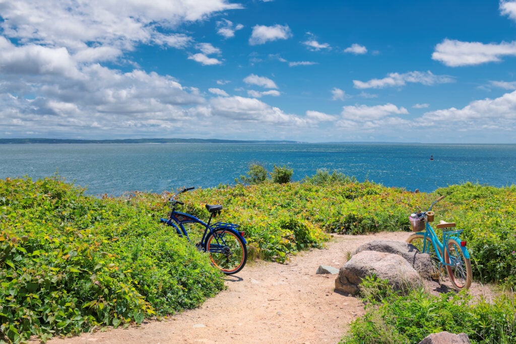 Two bicycles on the beach trail at sunny summer day in Cape Cod beach, Massachusetts.